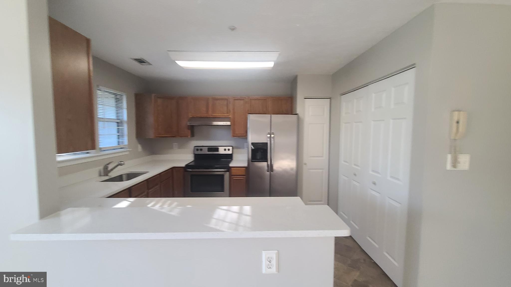 49 Bridle Lane, Unit 55 Nottingham, MD 21236 - Photo 4 of 17 a kitchen with a refrigerator sink and stove