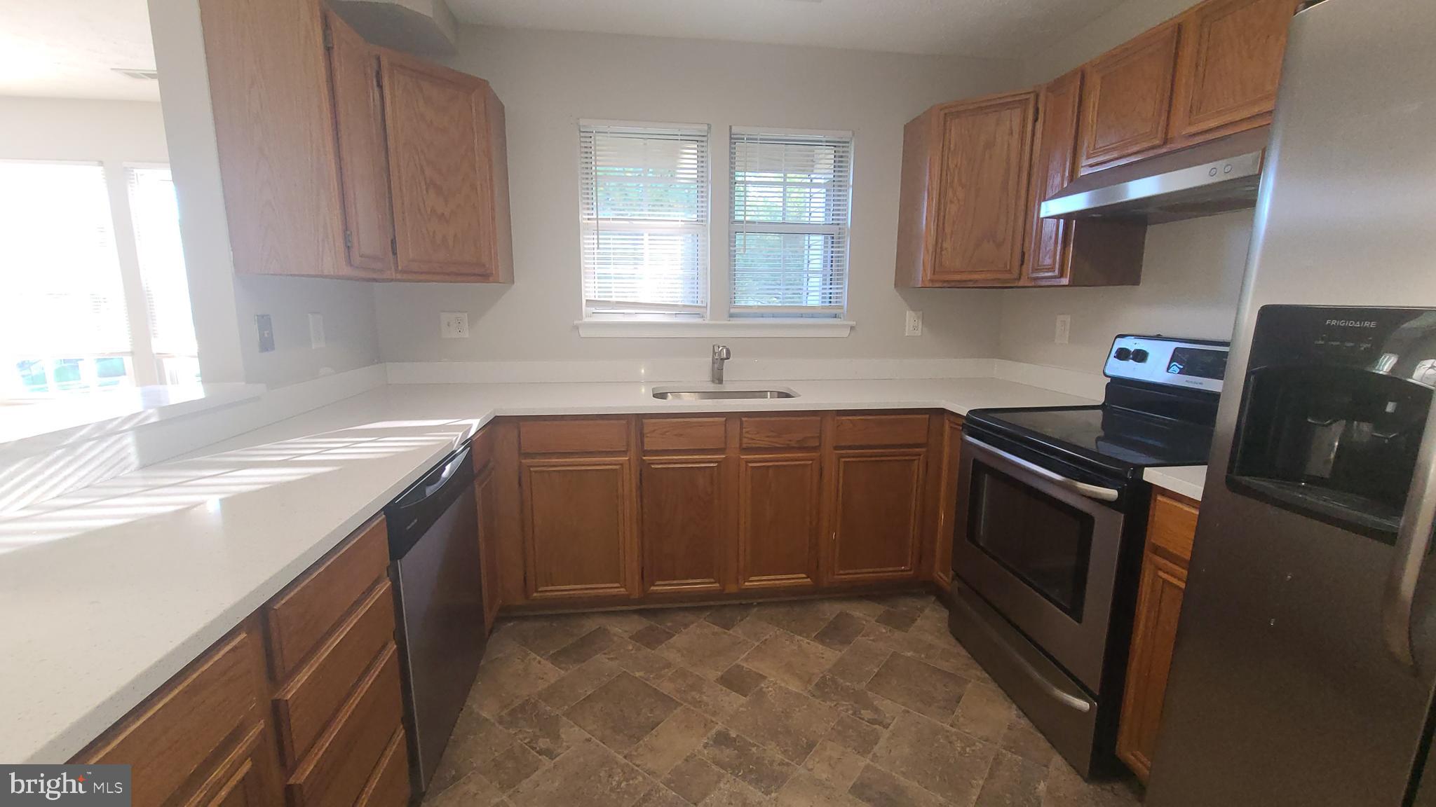 49 Bridle Lane, Unit 55 Nottingham, MD 21236 - Photo 6 of 17 a kitchen with a sink stove and cabinets