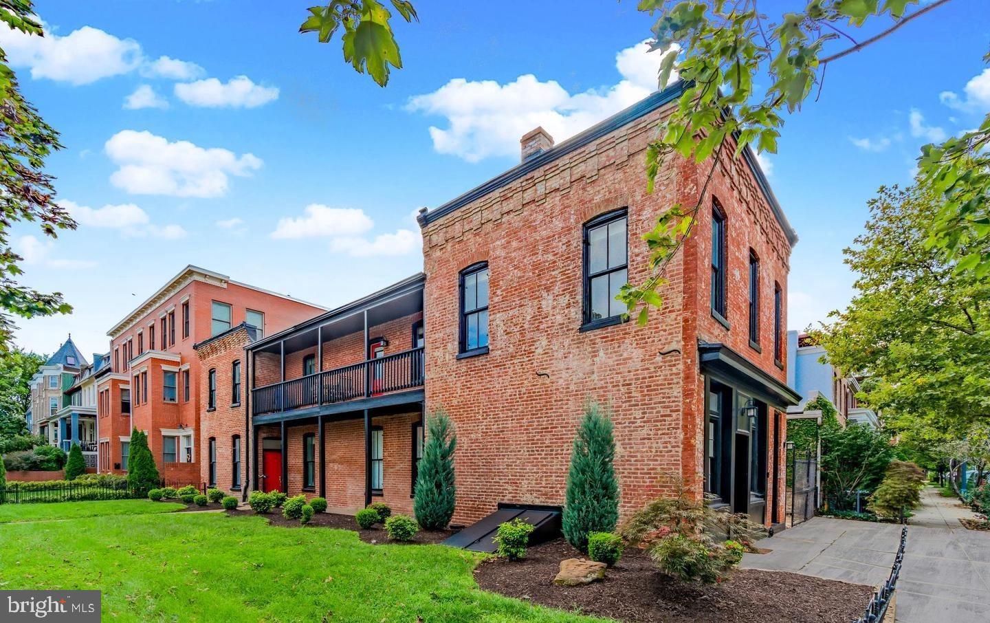 a view of a brick building with many windows
