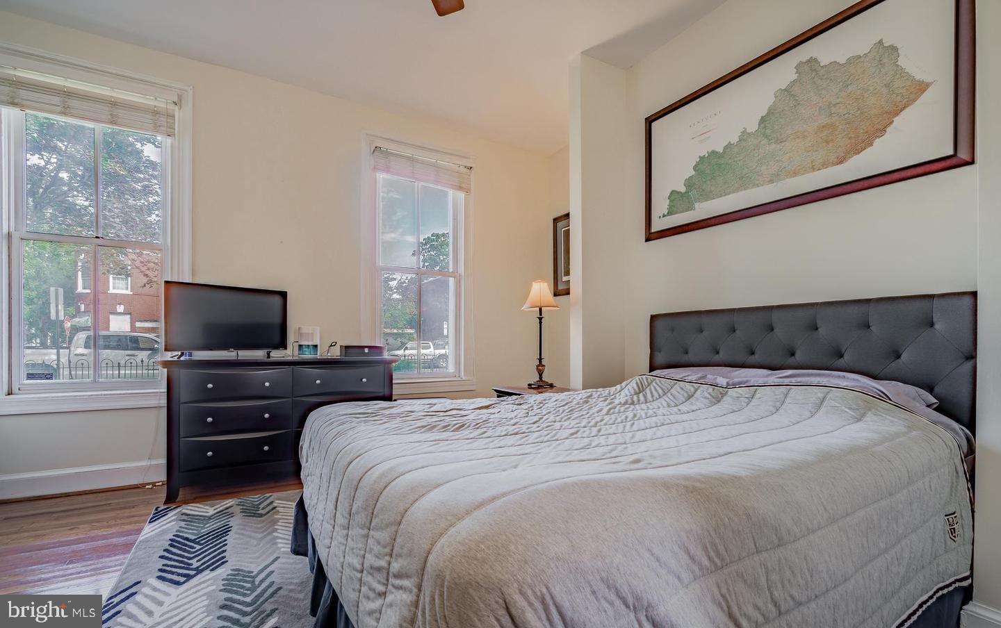 1133 D Street Northeast, Unit 1A Washington, DC 20002 - Photo 4 of 5 a bedroom with a bed and flat screen tv