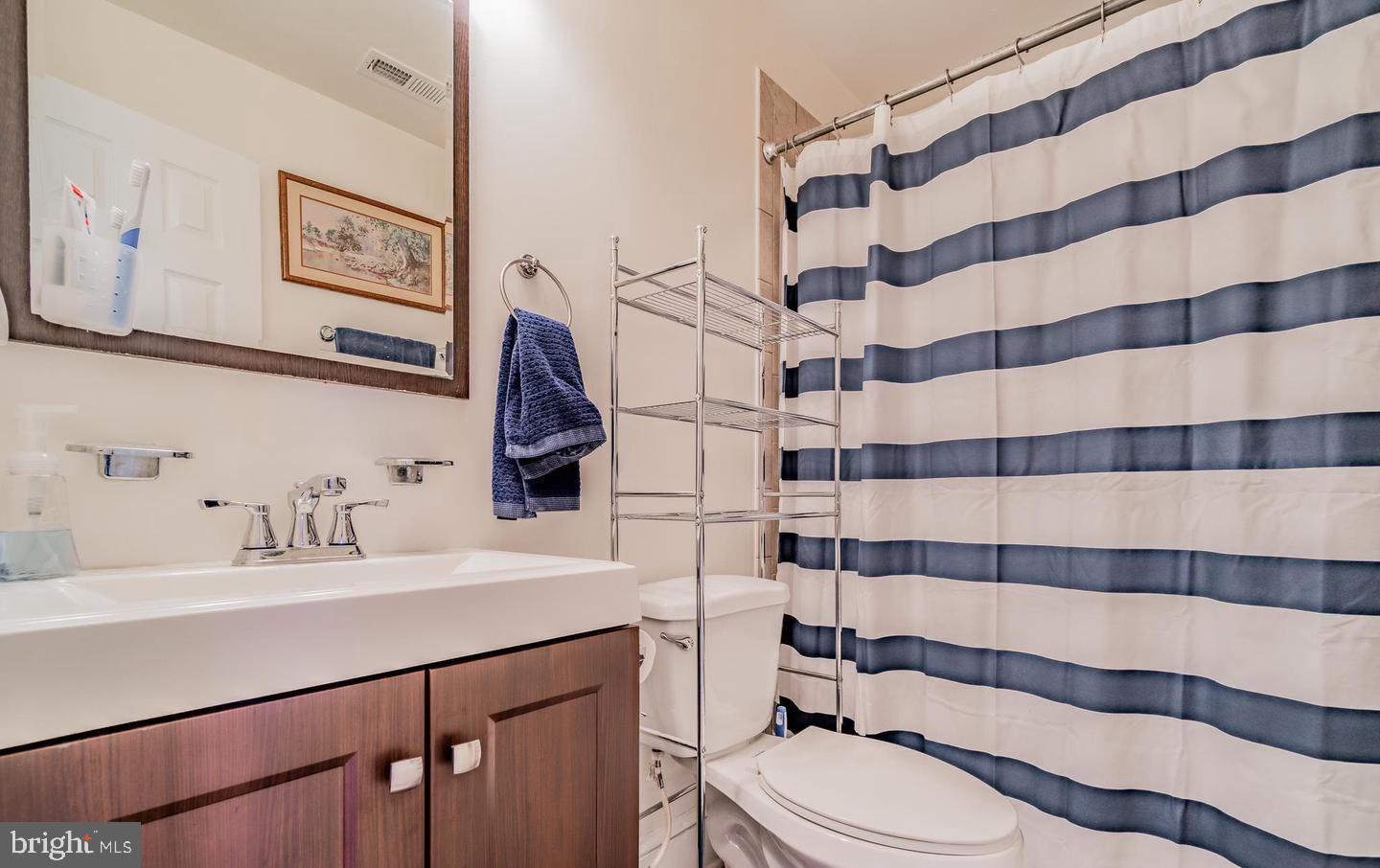 1133 D Street Northeast, Unit 1A Washington, DC 20002 - Photo 5 of 5 a bathroom with a sink toilet and shower