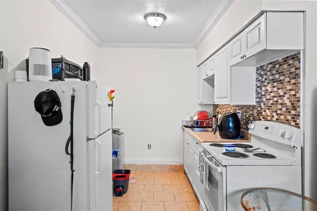 a kitchen with a refrigerator and a stove