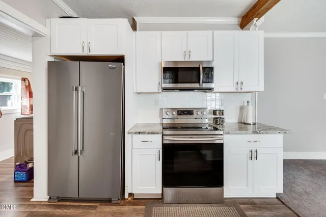 a kitchen with stainless steel appliances granite countertop a sink and a stove top oven