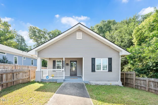 a view of a house with a yard and a garden