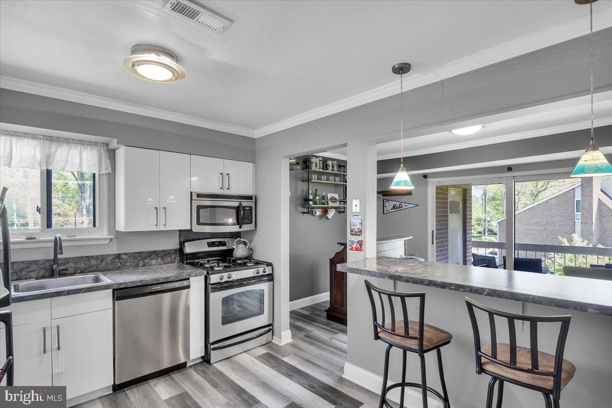 117 Echelon Road Voorhees, NJ 08043 - Photo 8 of 21 a kitchen with stainless steel appliances granite countertop a stove a sink and a refrigerator