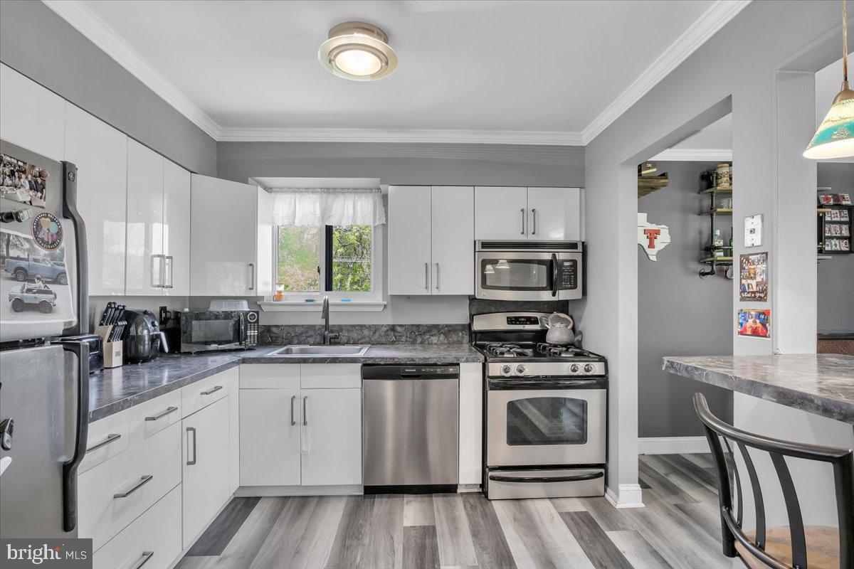 117 Echelon Road Voorhees, NJ 08043 - Photo 9 of 21 a kitchen with cabinets stainless steel appliances a sink and a stove