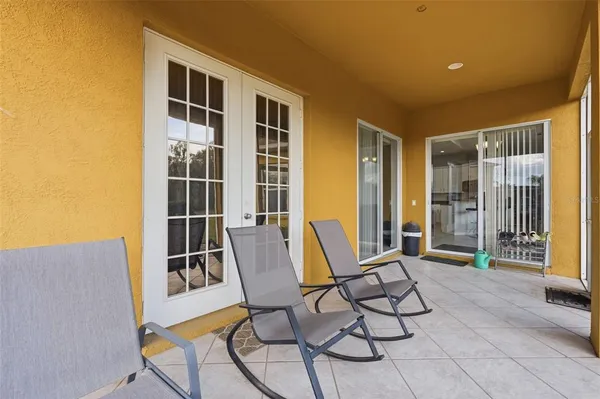 a view of swimming pool with dining table and chairs