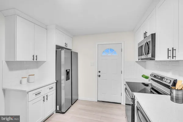 a kitchen with a stove a refrigerator and a sink