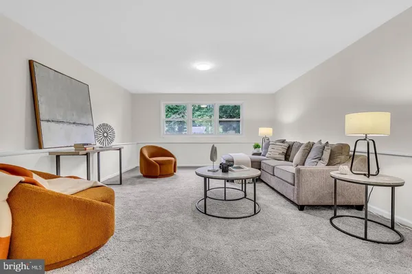 a living room with furniture a gym equipment and a large window