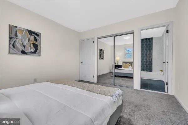 a bedroom with a bed and a painting on the wall
