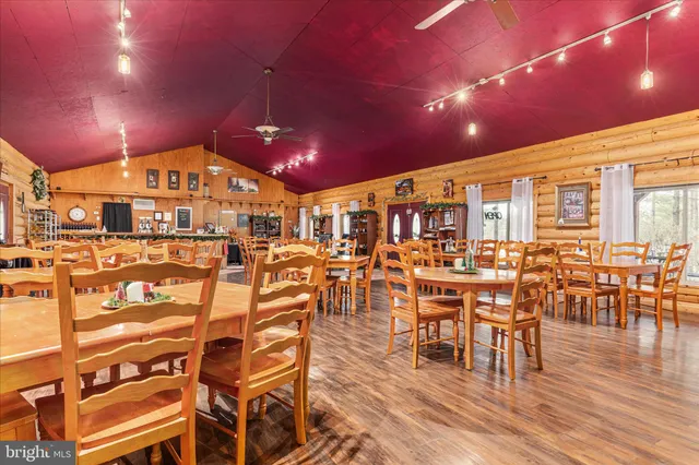 a view of a patio with table and chairs and floor to ceiling window with wooden floor