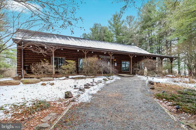 a view of a house with a yard covered in snow