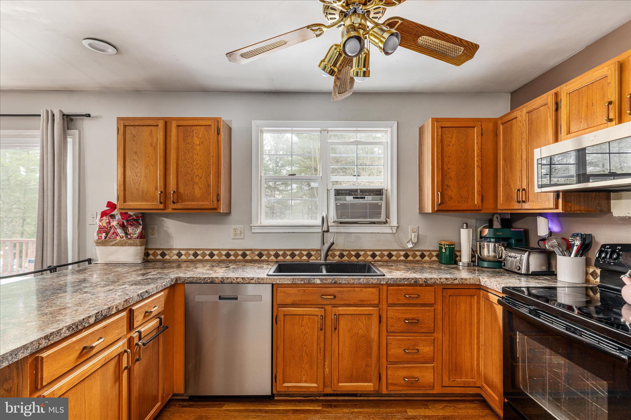 43301 Spinks Ferry Road Leesburg, VA 20176 - Photo 43 of 102 a kitchen with stainless steel appliances granite countertop a sink a stove cabinets counter space and a window