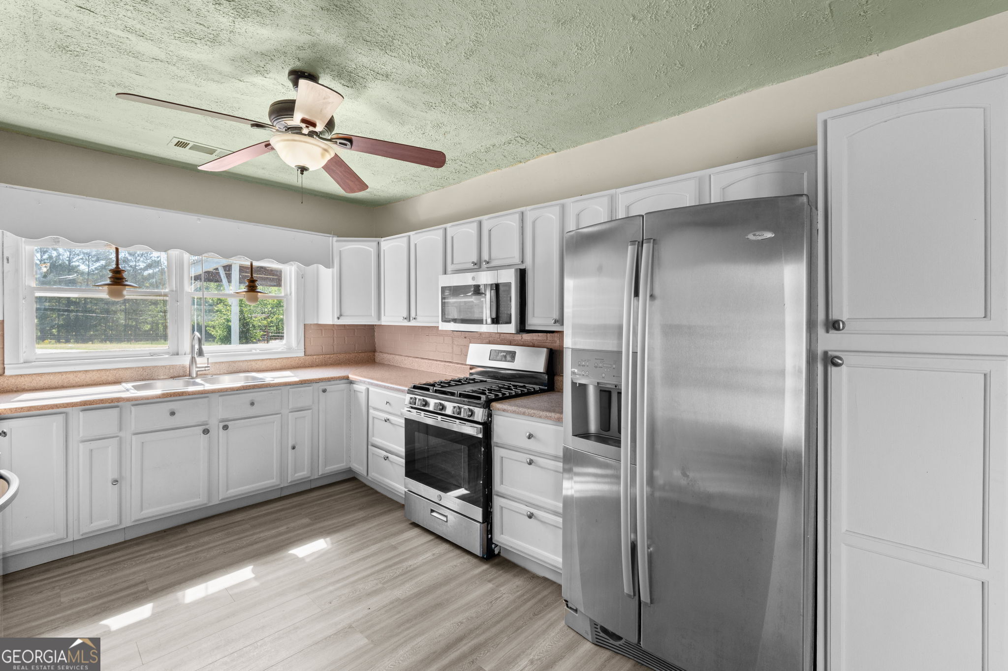 49 Frost Road Bowdon, GA 30108 - Photo 13 of 60 a large kitchen with cabinets and stainless steel appliances