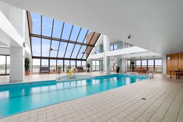 a living room with a floor to ceiling window and furniture