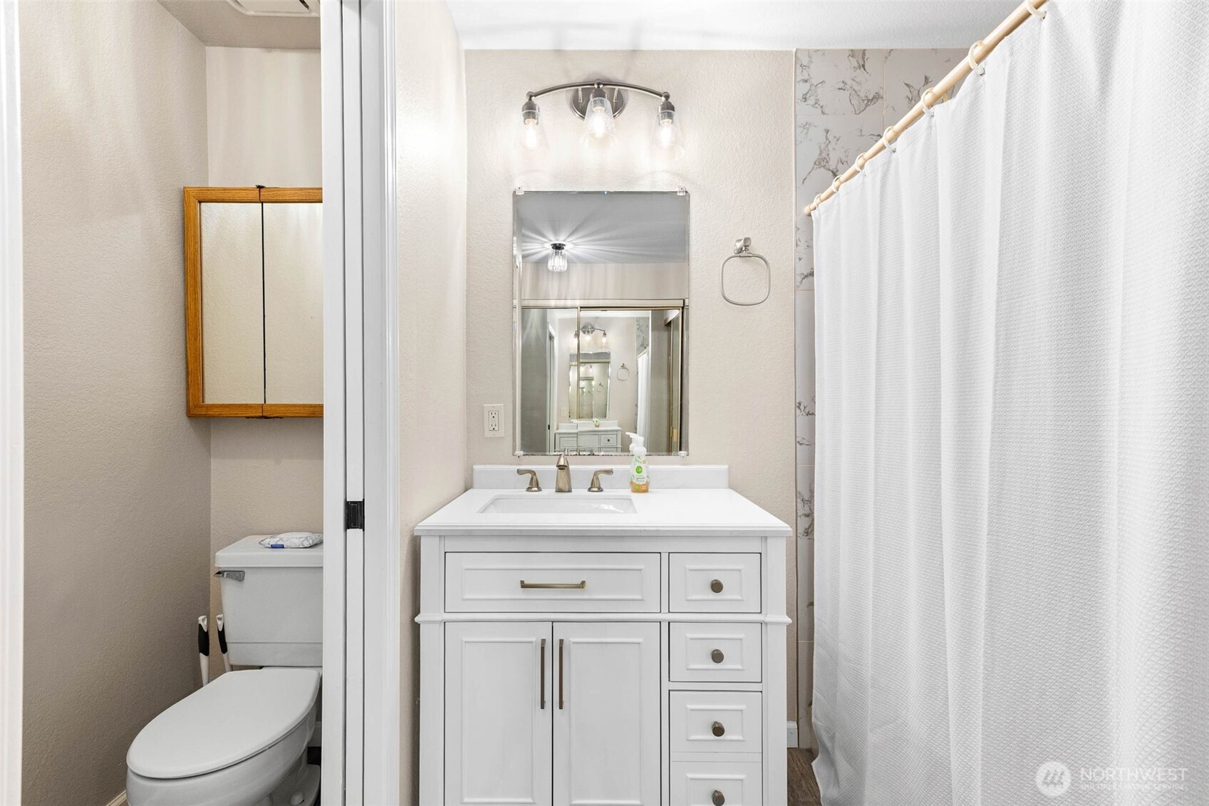 1002 South 312th Street, Unit 114 Federal Way, WA 98003 - Photo 15 of 39 a bathroom with a toilet a sink and a mirror