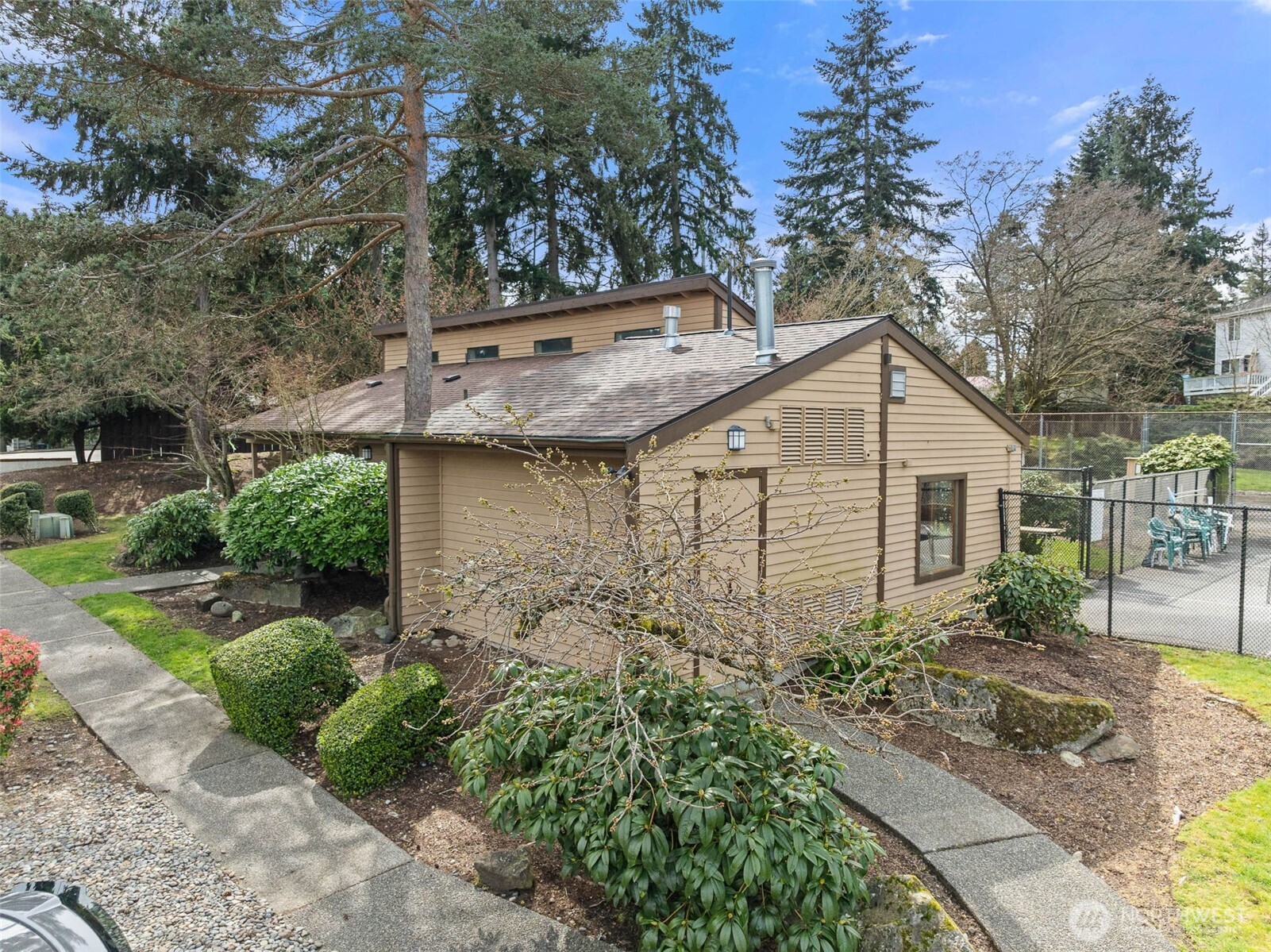 1002 South 312th Street, Unit 114 Federal Way, WA 98003 - Photo 30 of 39 a pathway of a house with potted plants and large trees