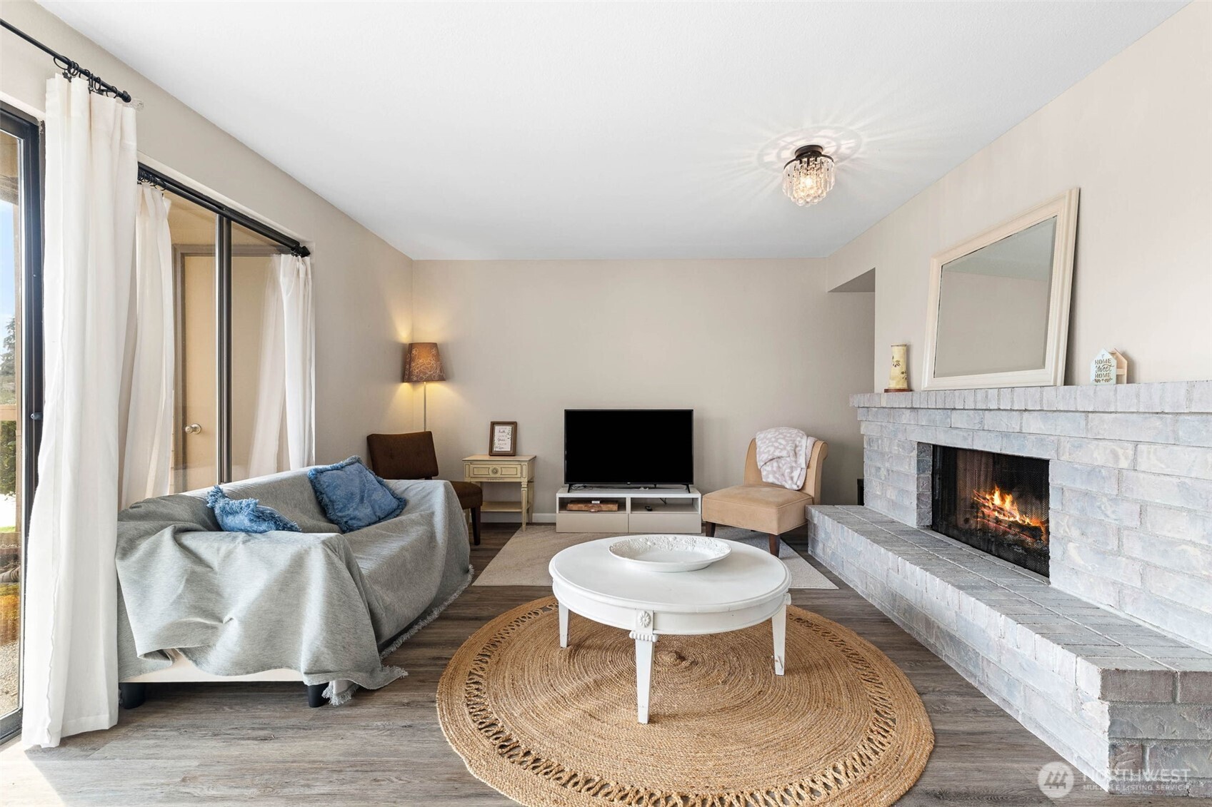 1002 South 312th Street, Unit 114 Federal Way, WA 98003 - Photo 4 of 39 a living room with furniture and a fireplace