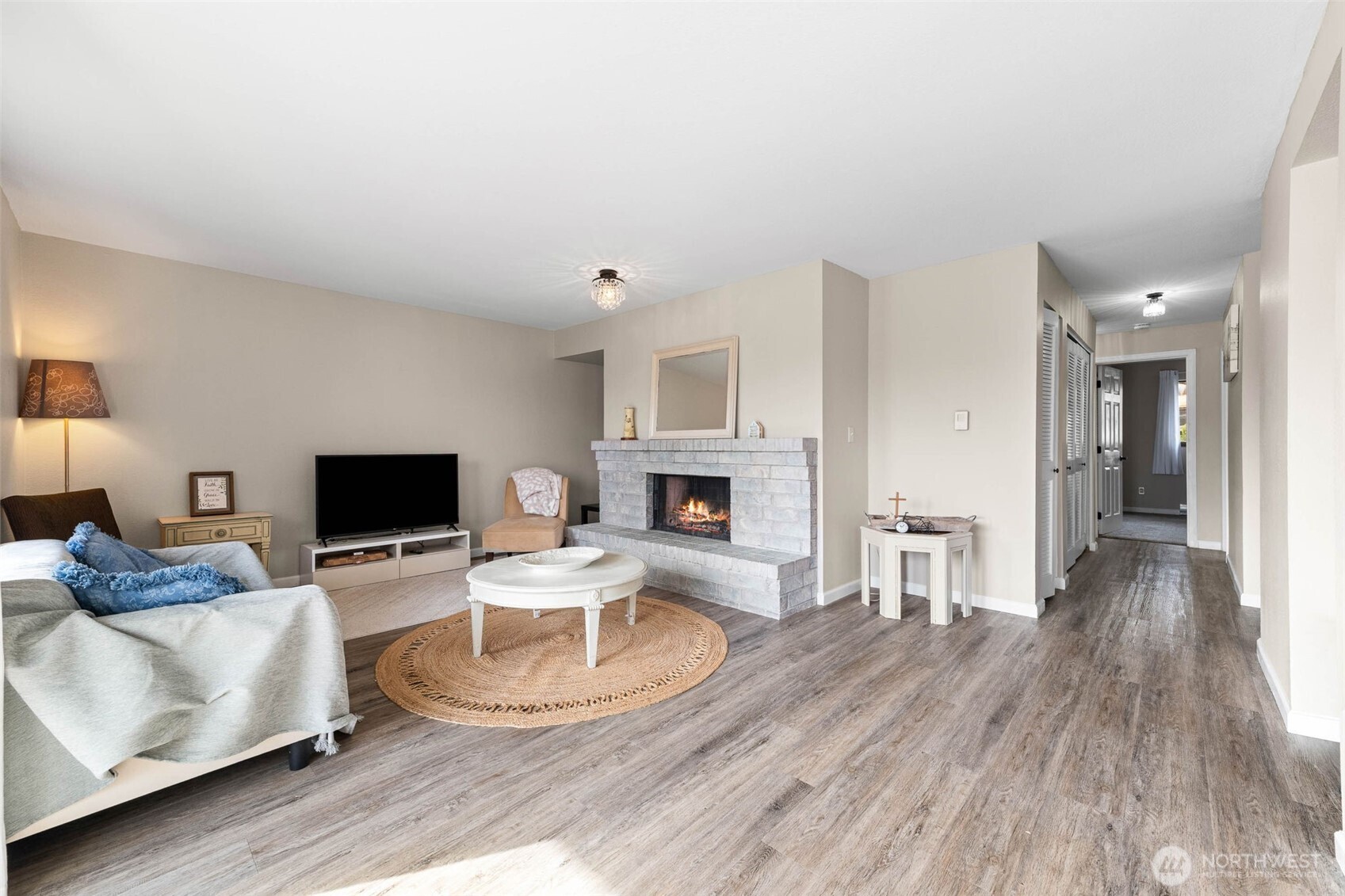 1002 South 312th Street, Unit 114 Federal Way, WA 98003 - Photo 5 of 39 a living room with furniture and a fireplace