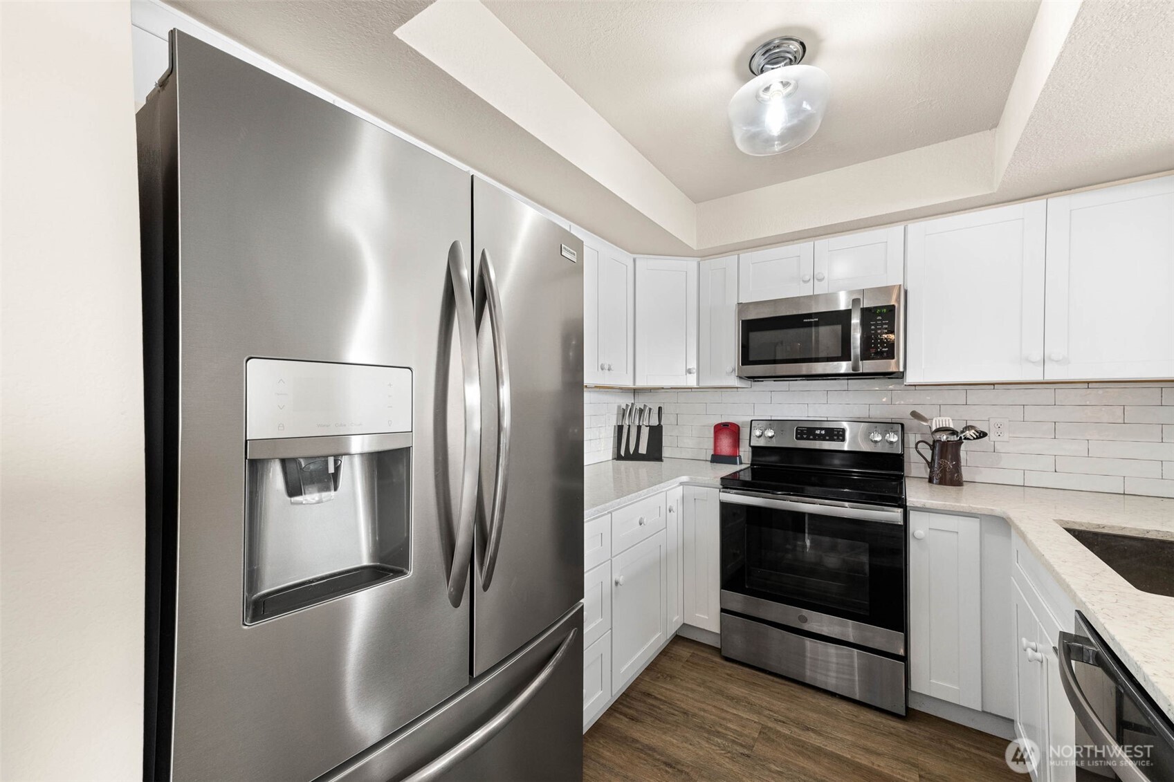 1002 South 312th Street, Unit 114 Federal Way, WA 98003 - Photo 8 of 39 a kitchen with stainless steel appliances and refrigerator