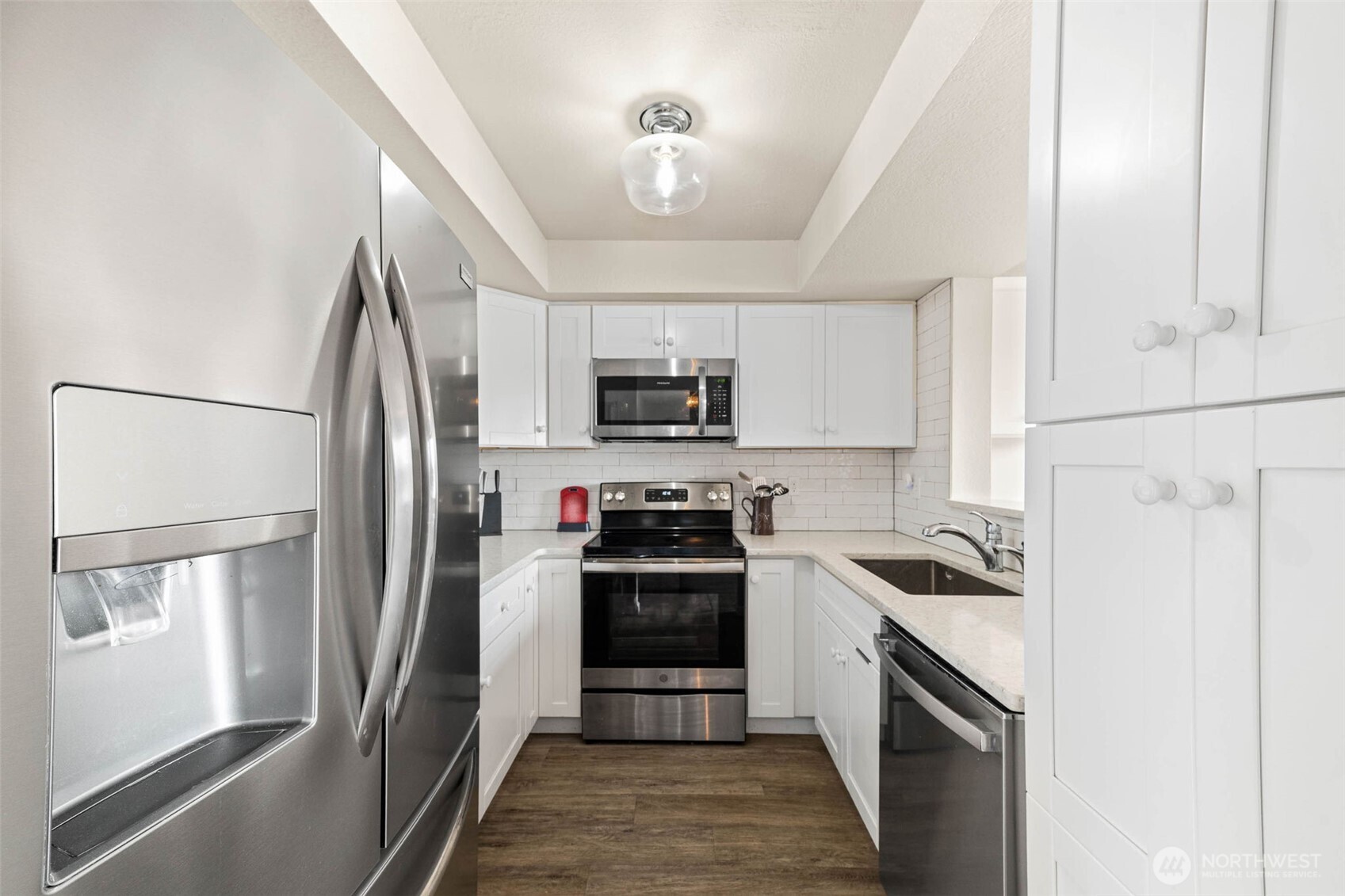 1002 South 312th Street, Unit 114 Federal Way, WA 98003 - Photo 9 of 39 a kitchen with stainless steel appliances a refrigerator stove and microwave