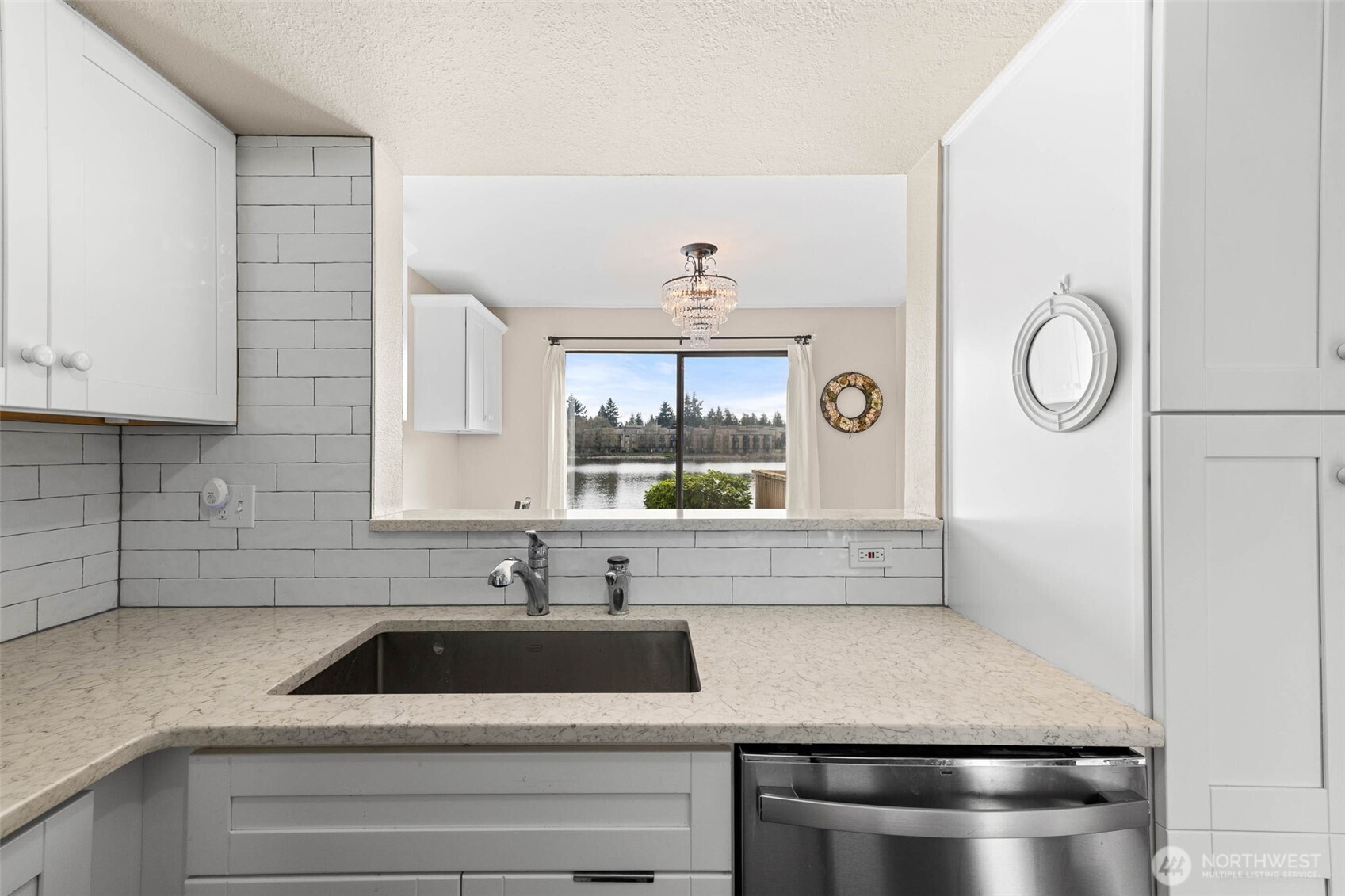 1002 South 312th Street, Unit 114 Federal Way, WA 98003 - Photo 10 of 39 a kitchen with a stove and a white cabinet