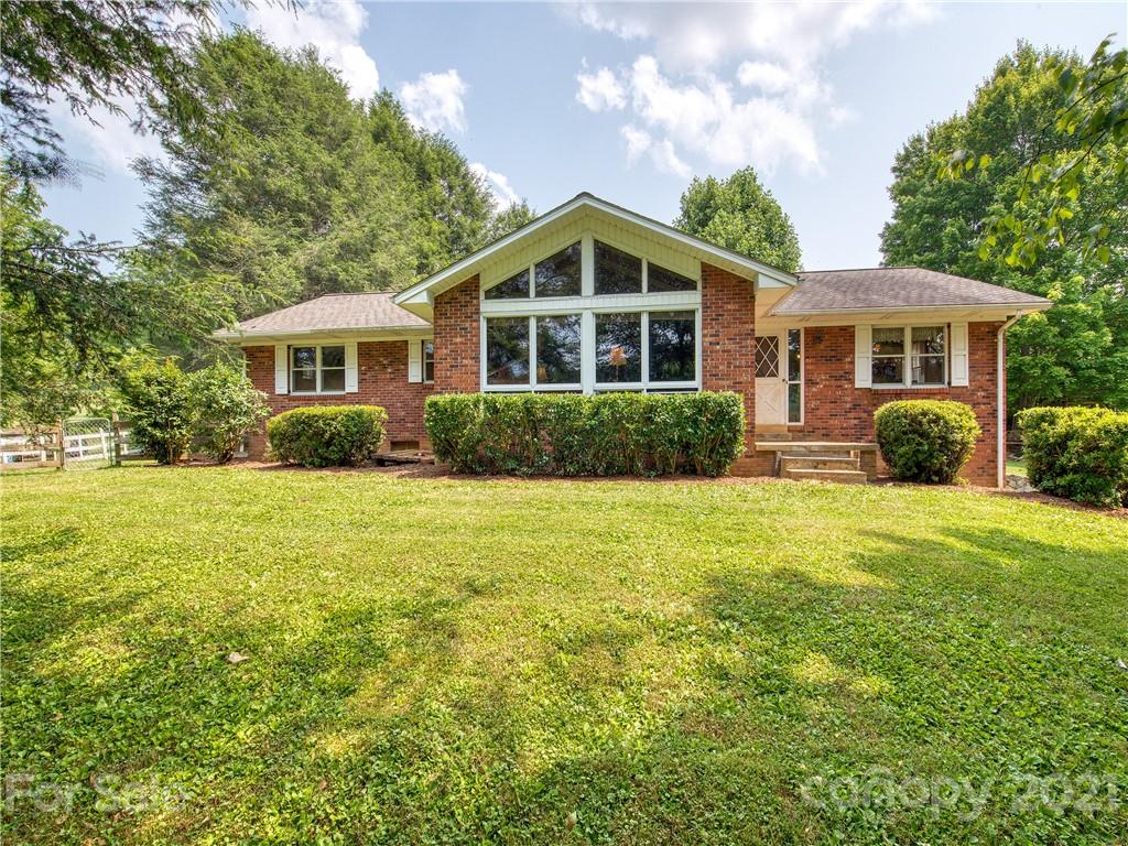 120 Arrowood Acres Road Clyde, NC 28721 - Photo 1 of 42 a view of a house with backyard and garden