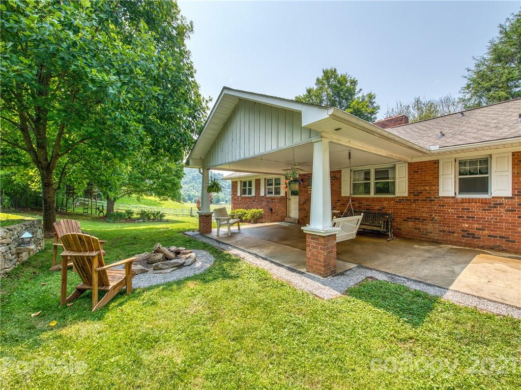 120 Arrowood Acres Road Clyde, NC 28721 - Photo 2 of 42 a view of a house with backyard sitting area and garden