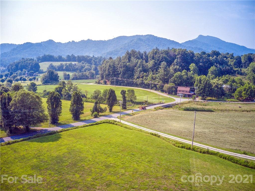 120 Arrowood Acres Road Clyde, NC 28721 - Photo 11 of 42 a view of an swimming pool with mountains in the background