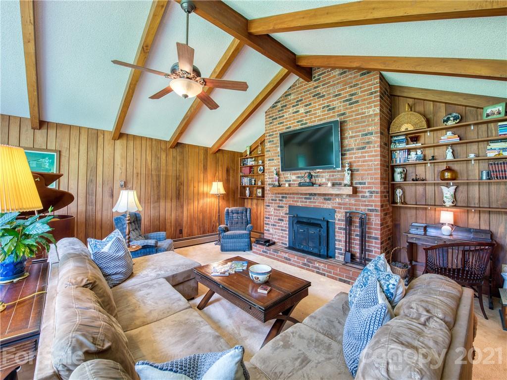 120 Arrowood Acres Road Clyde, NC 28721 - Photo 14 of 42 a living room with furniture a fireplace and a flat screen tv
