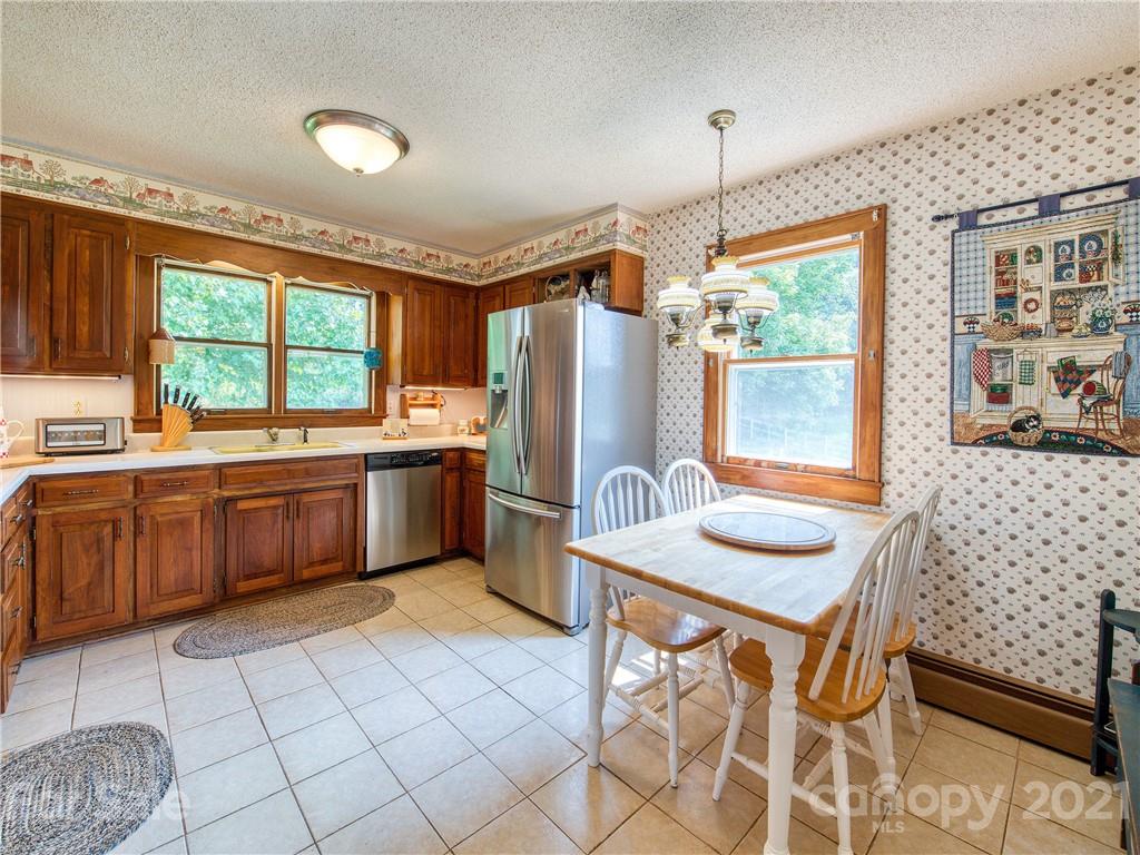 120 Arrowood Acres Road Clyde, NC 28721 - Photo 19 of 42 a kitchen with a sink window and cabinets