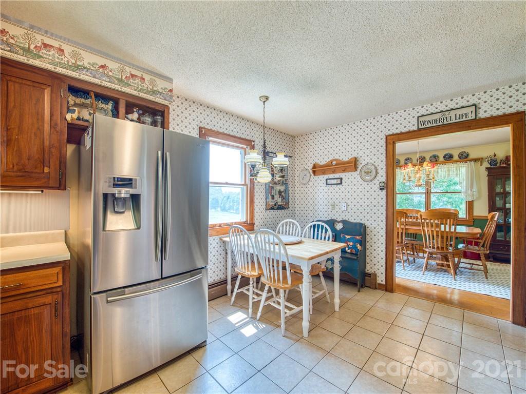 120 Arrowood Acres Road Clyde, NC 28721 - Photo 21 of 42 a kitchen with stainless steel appliances granite countertop a refrigerator and a stove top oven