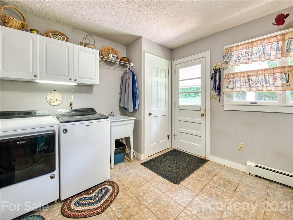 120 Arrowood Acres Road Clyde, NC 28721 - Photo 22 of 42 a kitchen with a stove and a white cabinet