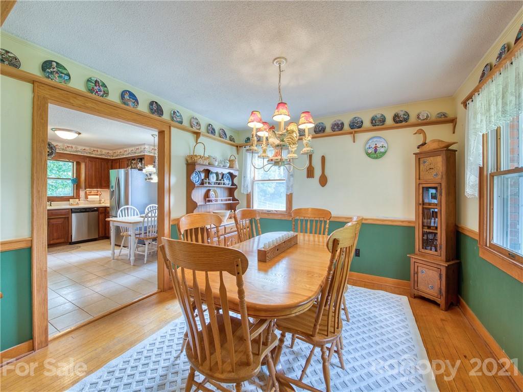 120 Arrowood Acres Road Clyde, NC 28721 - Photo 25 of 42 a view of a dining room with furniture and a chandelier