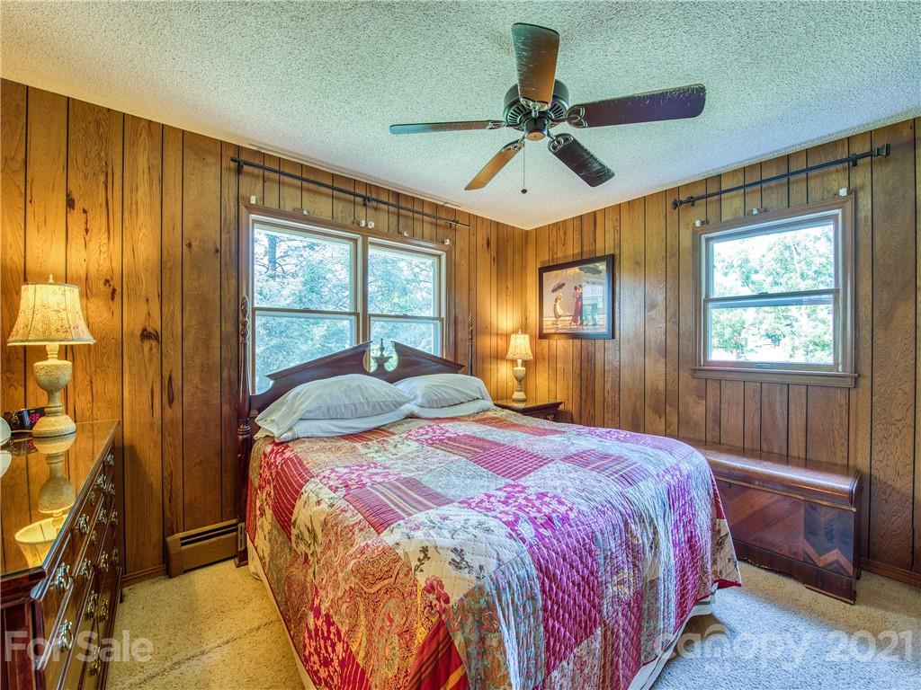 120 Arrowood Acres Road Clyde, NC 28721 - Photo 27 of 42 a bedroom with a bed and a window