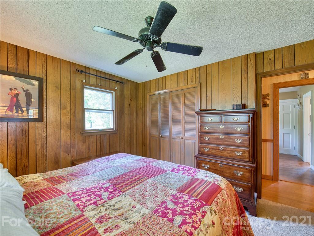120 Arrowood Acres Road Clyde, NC 28721 - Photo 29 of 42 a bedroom with a bed and a dresser