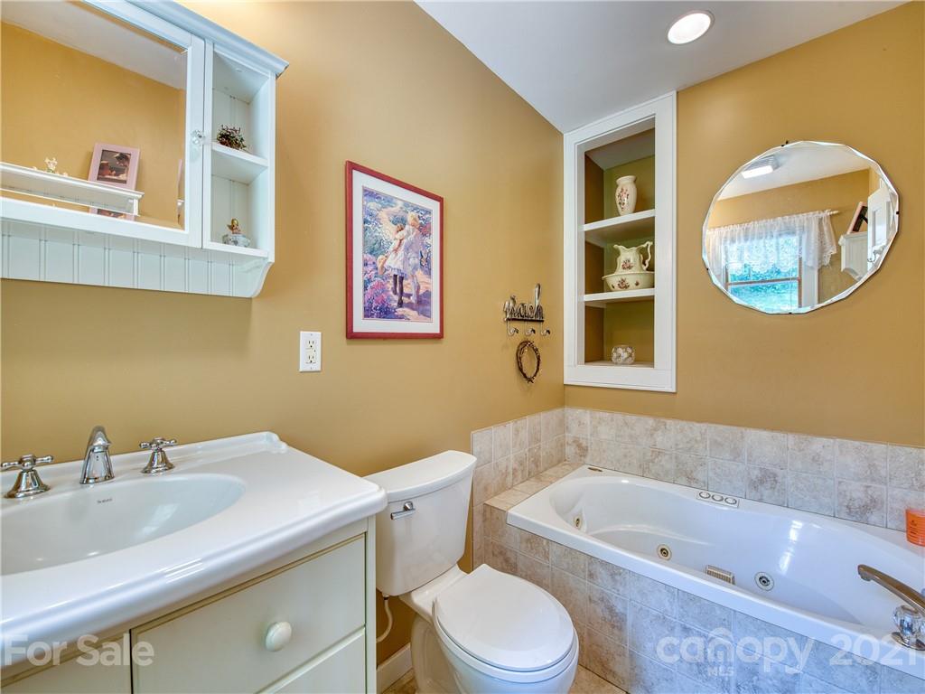 120 Arrowood Acres Road Clyde, NC 28721 - Photo 34 of 42 a bathroom with a toilet a sink and a bathtub
