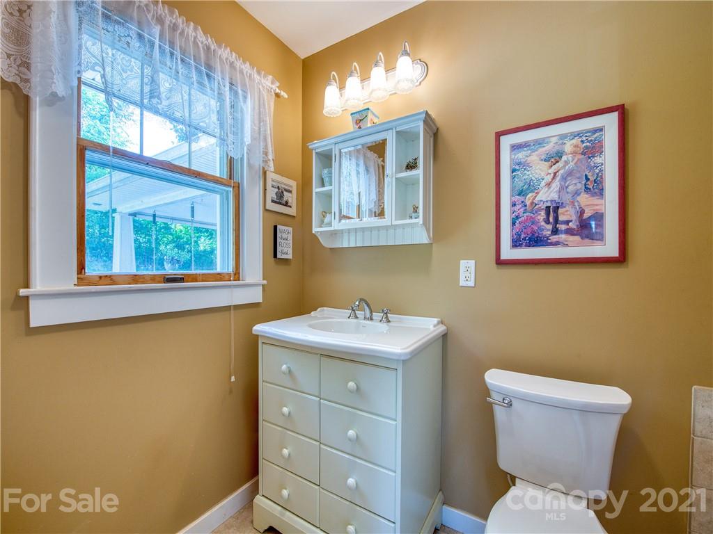 120 Arrowood Acres Road Clyde, NC 28721 - Photo 35 of 42 a bathroom with a toilet sink and mirror