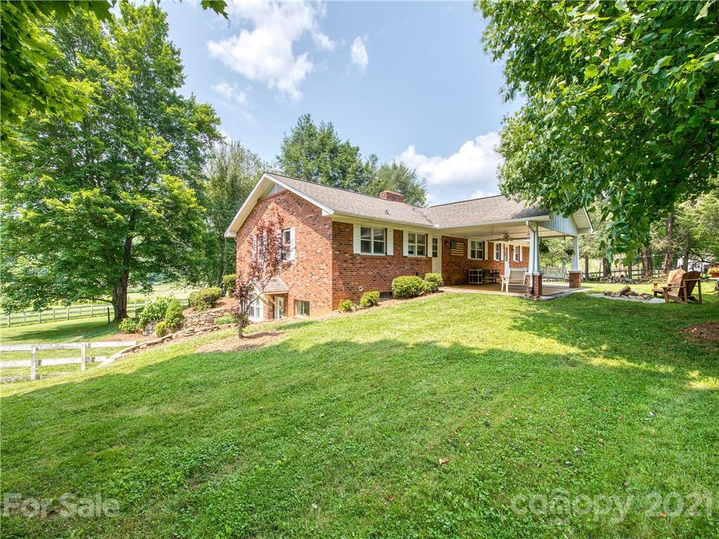 120 Arrowood Acres Road Clyde, NC 28721 - Photo 5 of 42 a view of a house with a big yard and large trees