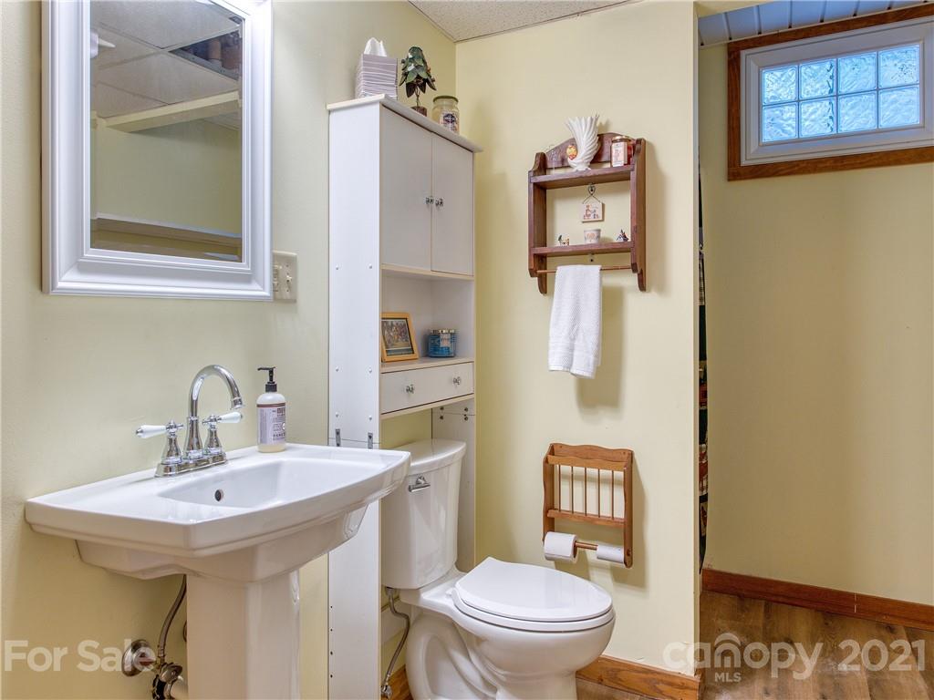 120 Arrowood Acres Road Clyde, NC 28721 - Photo 41 of 42 a bathroom with a toilet sink and mirror