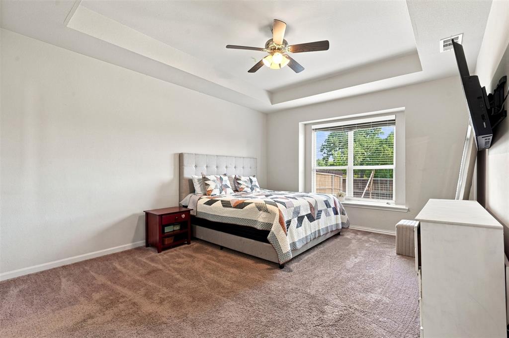 1321 Raleigh Path Denton, TX 76208 - Photo 22 of 35 Bedroom featuring a tray ceiling, recessed lighting, and a ceiling fan