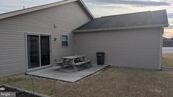 a backyard of a house with outdoor seating
