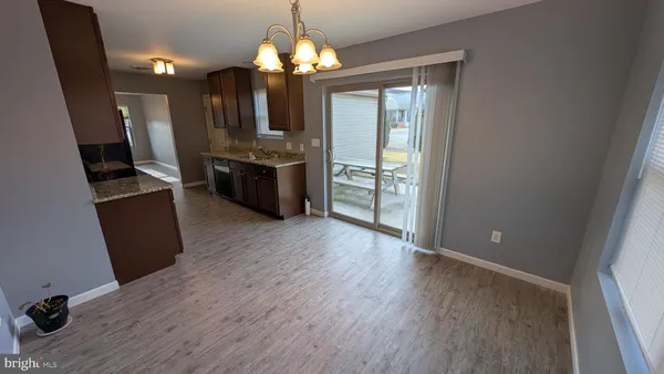 a large kitchen with a wooden floor
