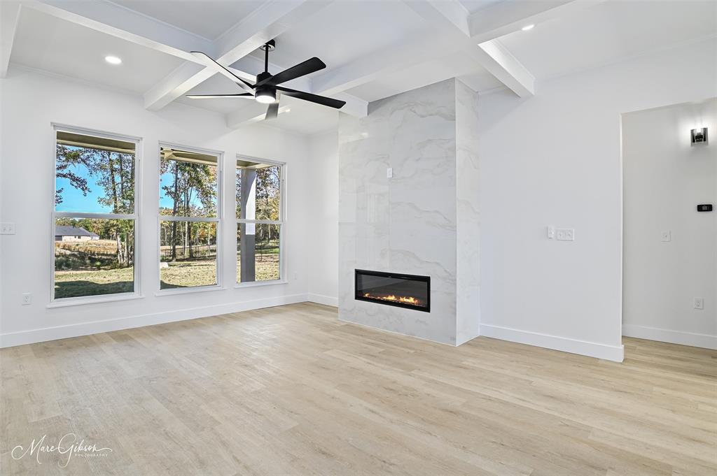 674 Rambin Road Stonewall, LA 71078 - Photo 6 of 26 an empty room with windows and fireplace