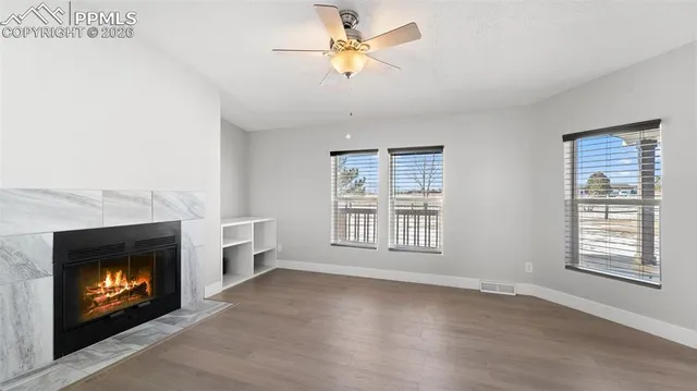 a large kitchen with stainless steel appliances granite countertop a stove top oven a sink and white cabinets