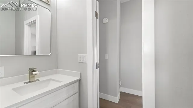 an empty room with windows and ceiling fan