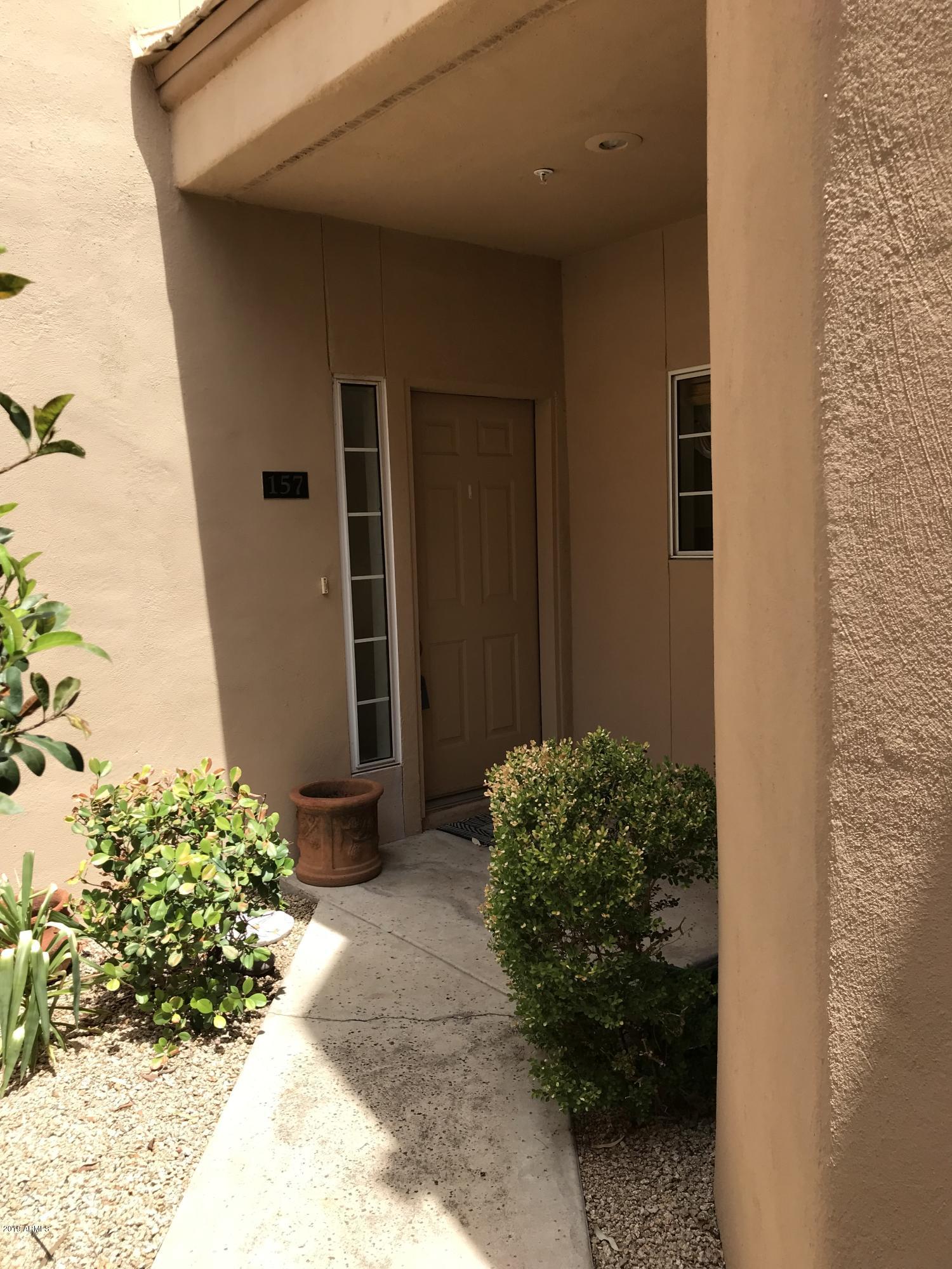 7710 East Gainey Ranch Road, Unit 157 Scottsdale, AZ 85258 - Photo 1 of 16 a couple of potted plants in front of door