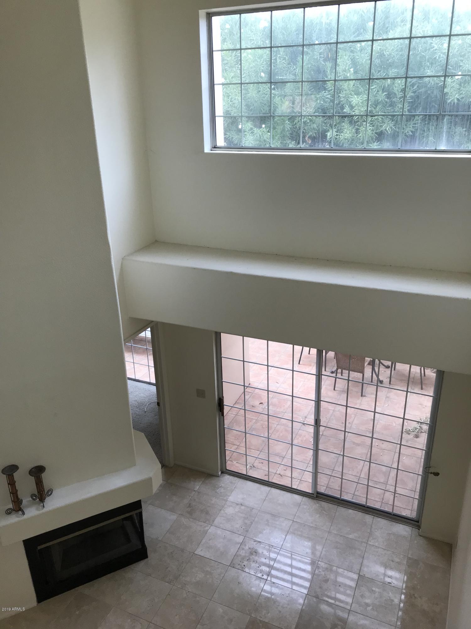 7710 East Gainey Ranch Road, Unit 157 Scottsdale, AZ 85258 - Photo 11 of 16 a view of a livingroom with an empty space and window