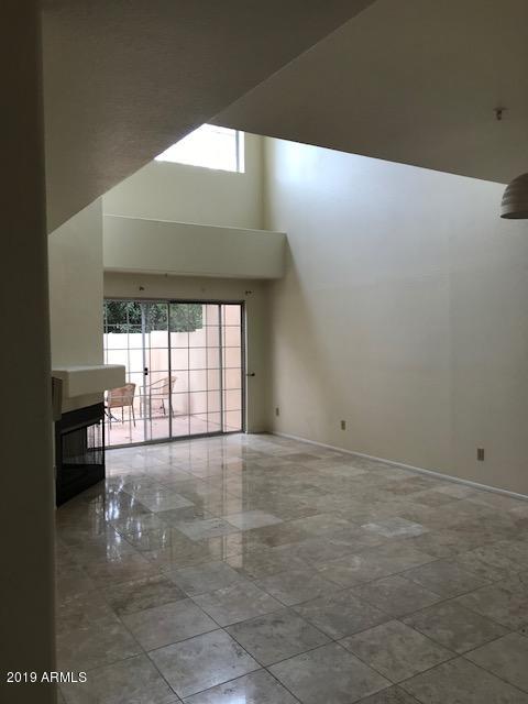 7710 East Gainey Ranch Road, Unit 157 Scottsdale, AZ 85258 - Photo 14 of 16 a view of an empty room with a fireplace
