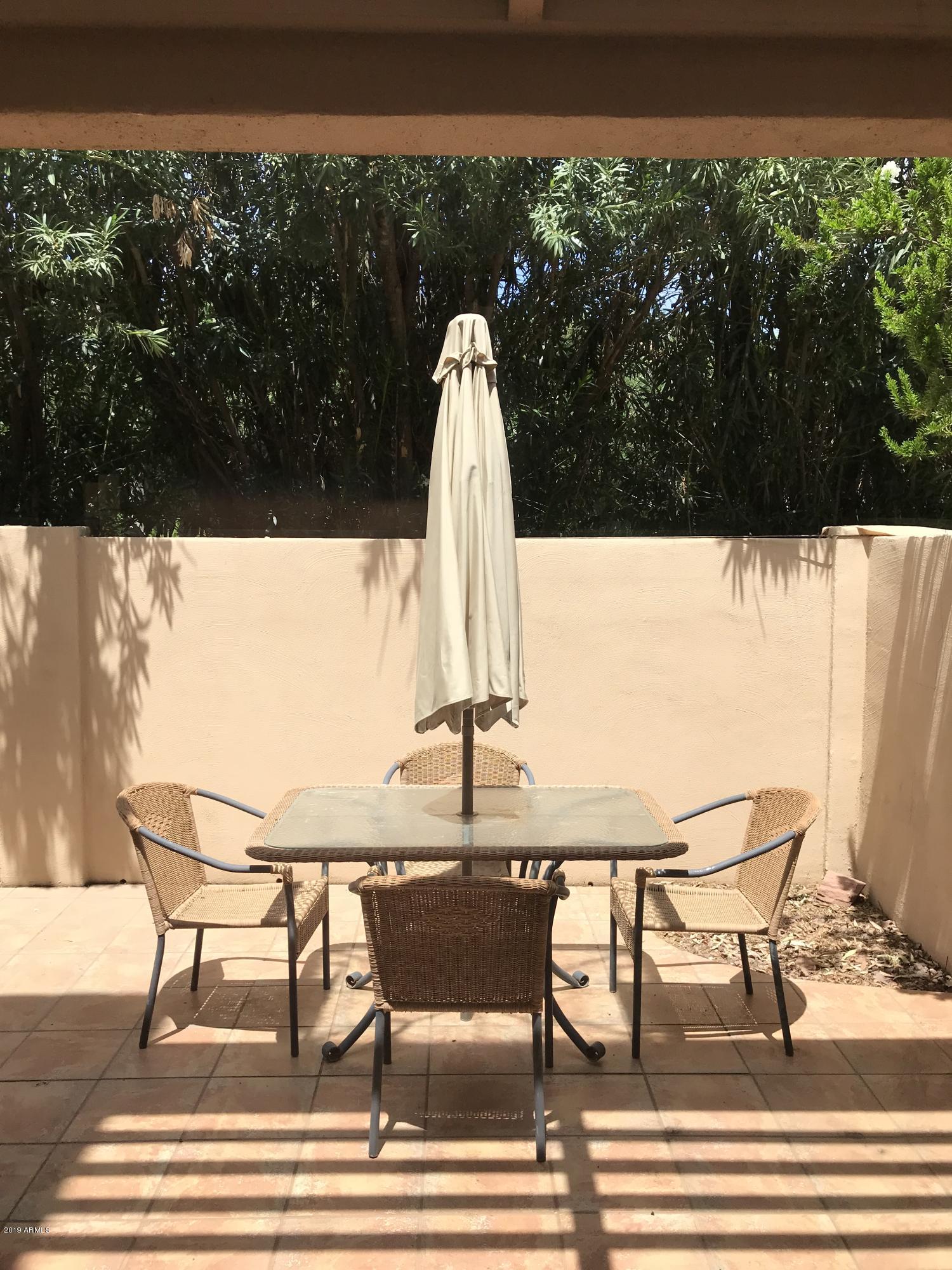 7710 East Gainey Ranch Road, Unit 157 Scottsdale, AZ 85258 - Photo 6 of 16 a view of a swimming pool with a lounge chair